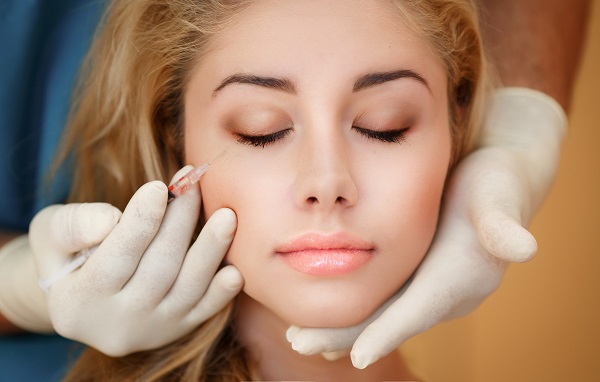 woman-with-eyes-closed-getting-dermal-filler-injection